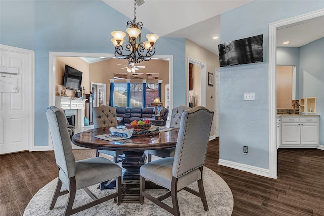 dining space with vaulted ceiling, an inviting chandelier, and dark hardwood / wood-style flooring