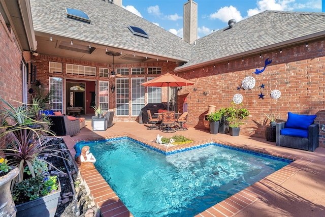 view of swimming pool with a patio area