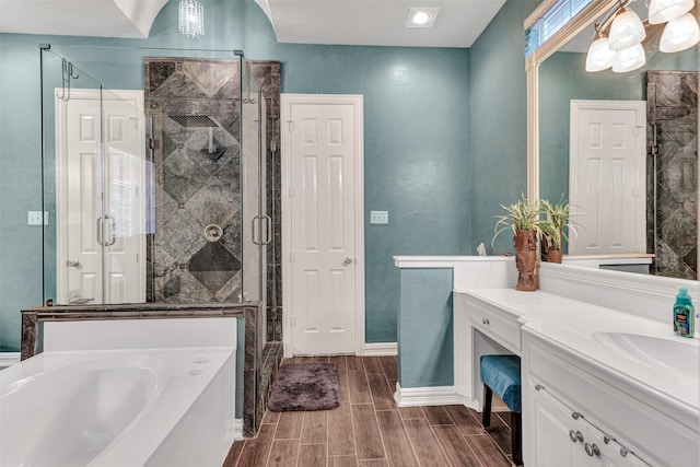 bathroom with hardwood / wood-style floors, vanity, and independent shower and bath