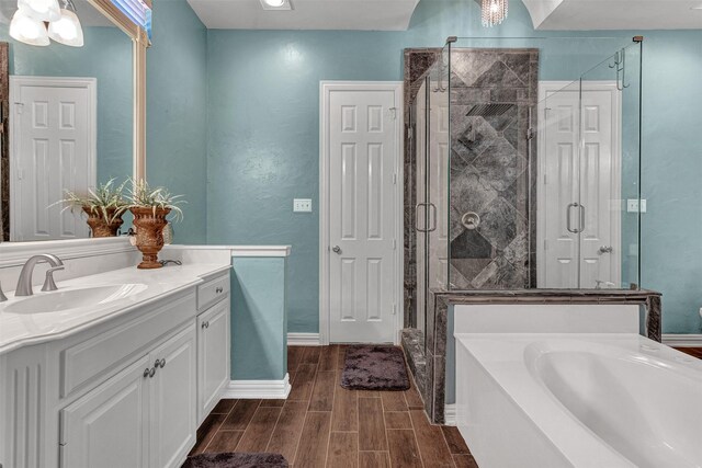 bathroom with vanity, independent shower and bath, and hardwood / wood-style flooring