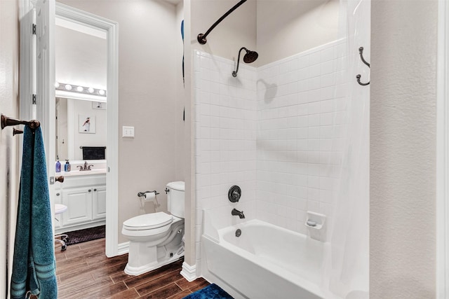 full bathroom featuring wood-type flooring, vanity, shower / bath combination, and toilet