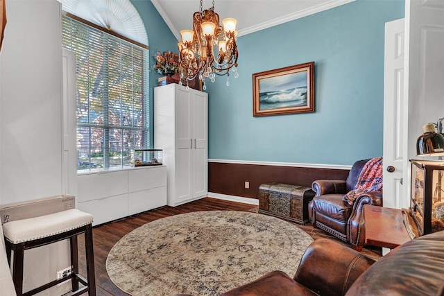 sitting room featuring dark hardwood / wood-style flooring, a chandelier, vaulted ceiling, and ornamental molding