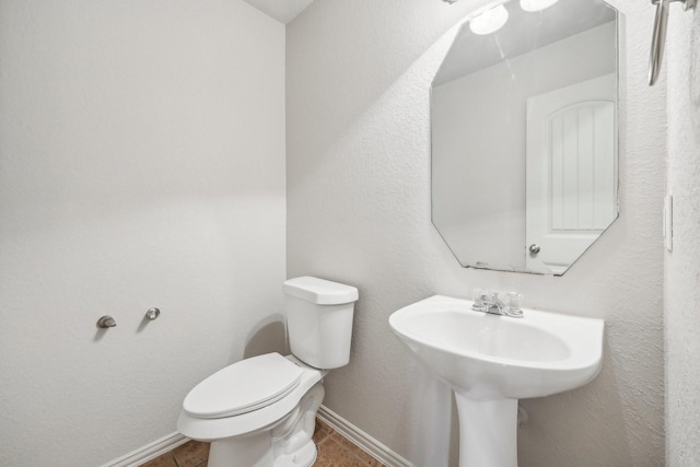 bathroom with tile patterned floors and toilet