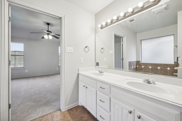 bathroom with tile patterned flooring, vanity, and ceiling fan