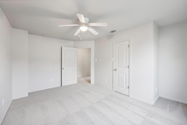 unfurnished room featuring light colored carpet and ceiling fan