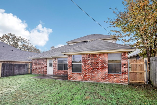 back of property featuring a yard