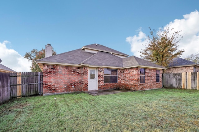 rear view of house with a lawn