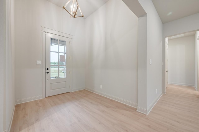 entryway featuring a chandelier and light hardwood / wood-style flooring