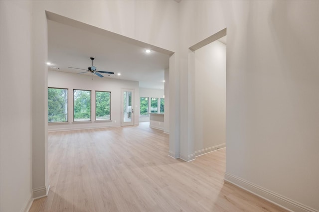 unfurnished living room with ceiling fan and light hardwood / wood-style flooring