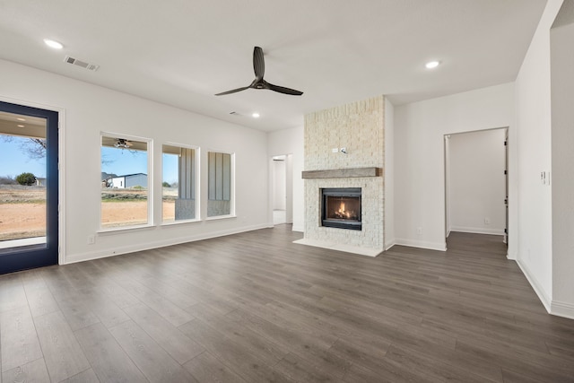 unfurnished living room with dark wood finished floors, recessed lighting, visible vents, a large fireplace, and ceiling fan