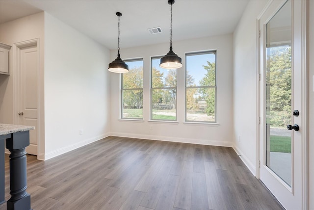 unfurnished dining area with hardwood / wood-style flooring