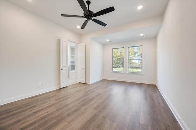 unfurnished room featuring light hardwood / wood-style flooring and ceiling fan