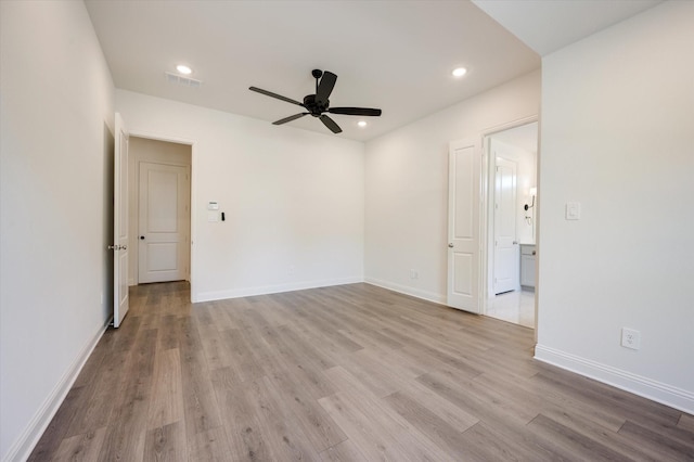 spare room featuring ceiling fan and light hardwood / wood-style floors