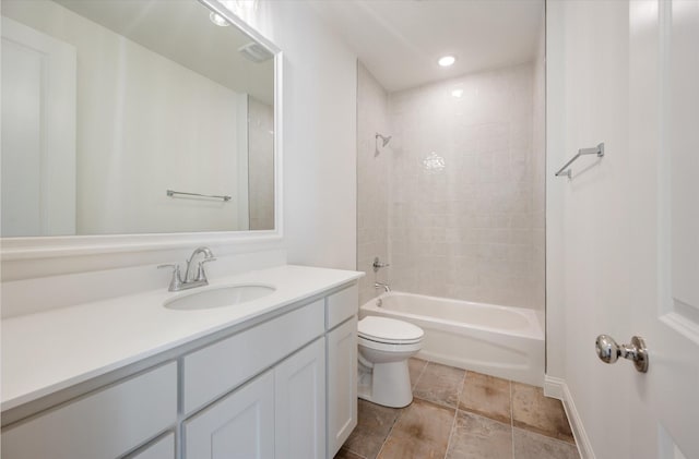 full bathroom featuring vanity, tiled shower / bath combo, and toilet