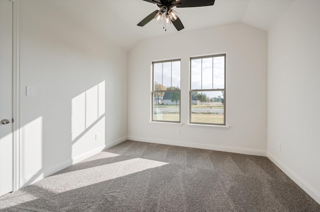 spare room with carpet, vaulted ceiling, and ceiling fan