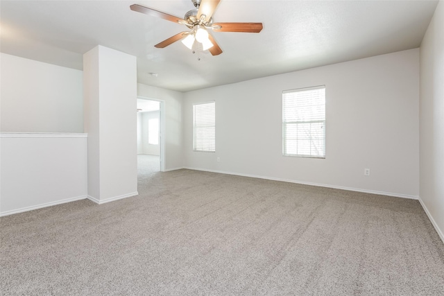 carpeted spare room with ceiling fan