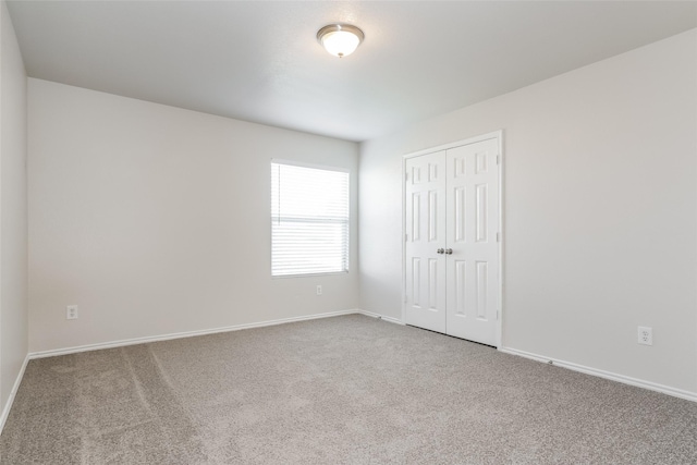 unfurnished room featuring carpet flooring