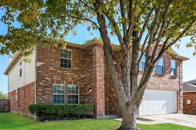 view of front of property with a garage and a front lawn