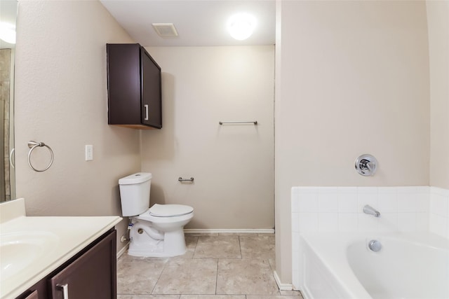 bathroom with vanity, toilet, tile patterned flooring, and a tub