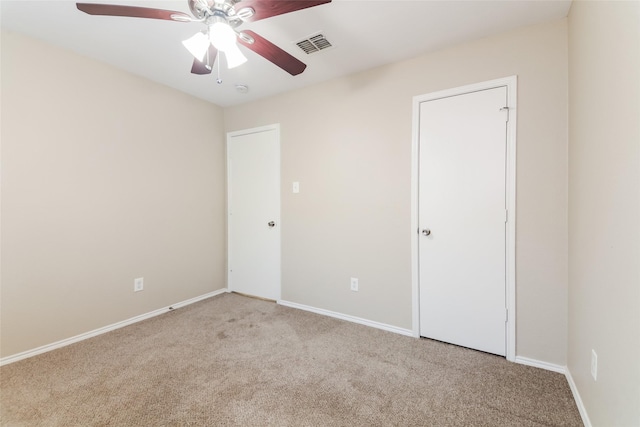 unfurnished room featuring ceiling fan and light carpet