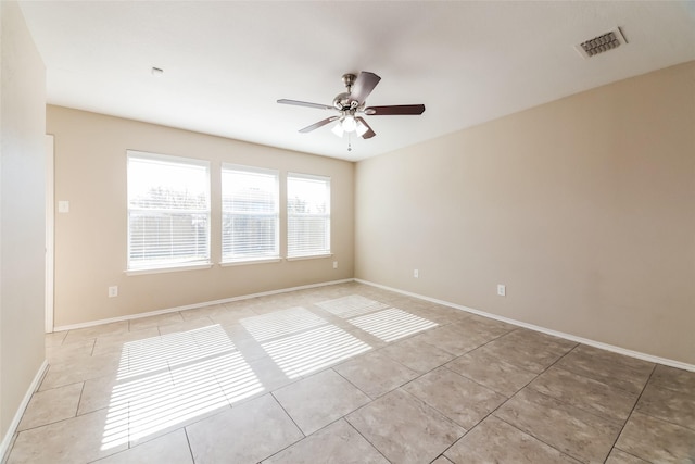empty room with light tile patterned floors and ceiling fan