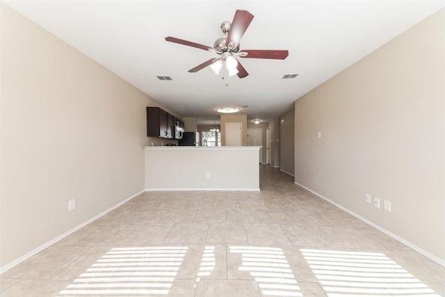 unfurnished living room with light tile patterned floors and ceiling fan