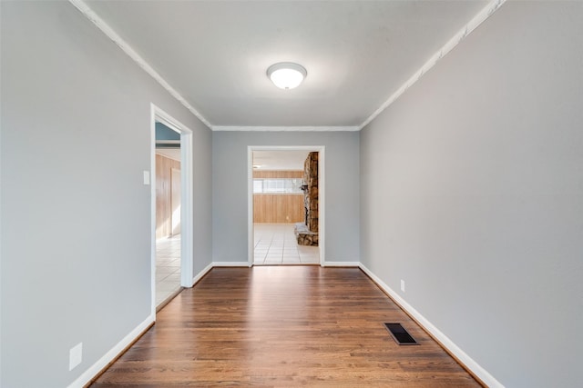 empty room featuring hardwood / wood-style floors and ornamental molding