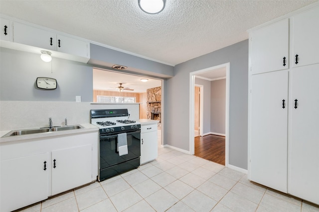 kitchen featuring sink, white cabinets, and white gas range oven