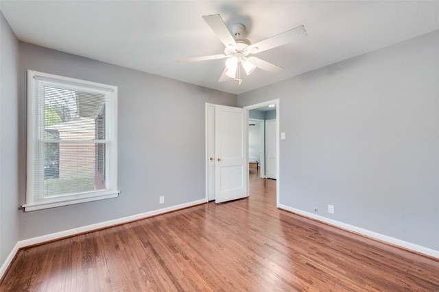 unfurnished room with ceiling fan and light wood-type flooring