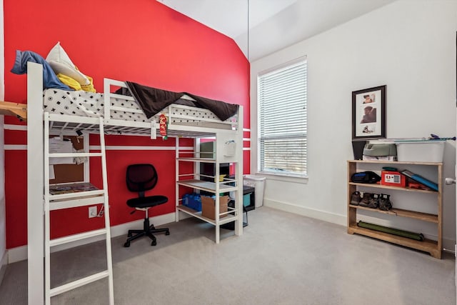 bedroom featuring carpet and lofted ceiling