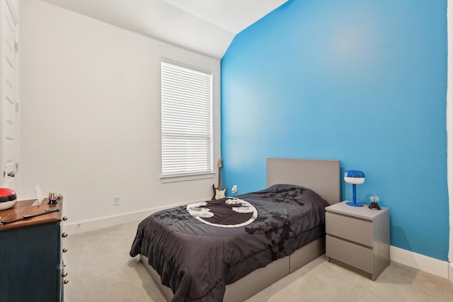 bedroom featuring multiple windows, light carpet, and lofted ceiling