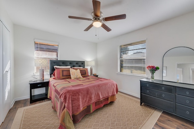 bedroom featuring light hardwood / wood-style floors, multiple windows, and ceiling fan