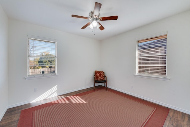 empty room with ceiling fan and dark wood-type flooring