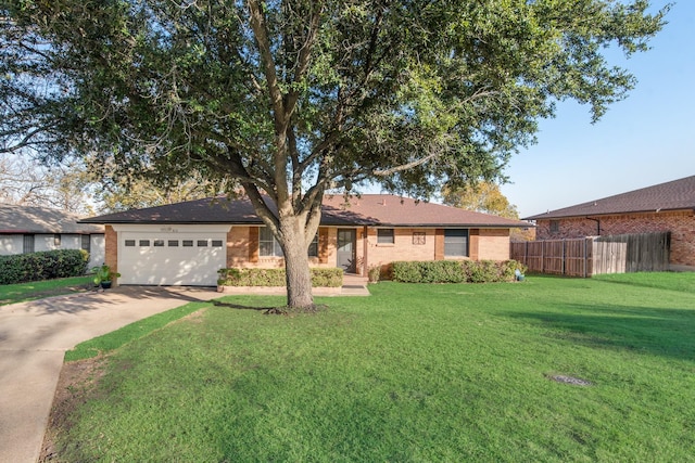 single story home featuring a garage and a front lawn