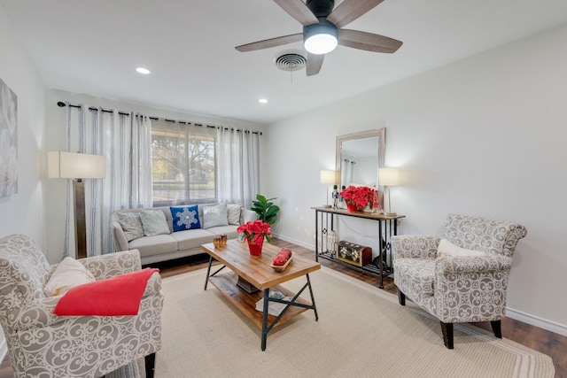 living room featuring light hardwood / wood-style floors and ceiling fan