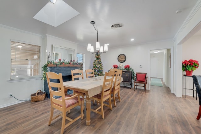 dining room featuring dark hardwood / wood-style floors, a healthy amount of sunlight, and crown molding