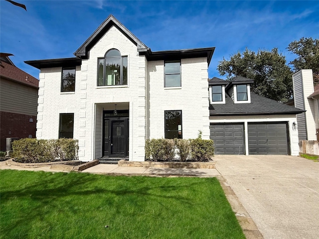 view of front of home with a front yard and a garage