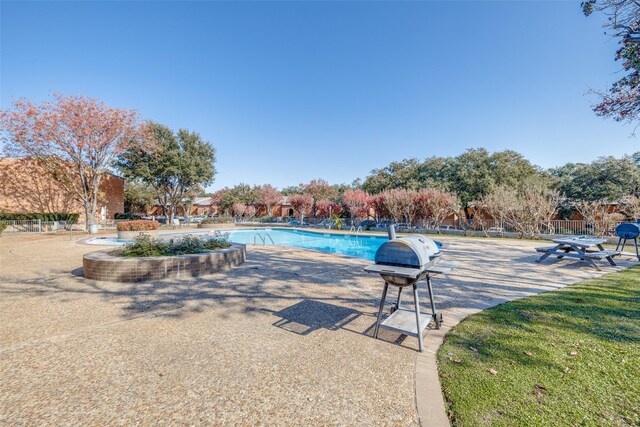 view of pool with a grill and a patio area