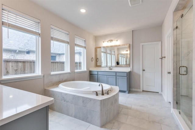 bathroom with shower with separate bathtub and vanity