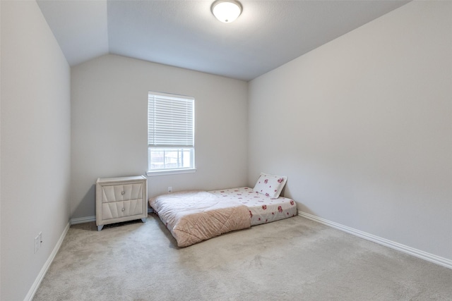 carpeted bedroom featuring lofted ceiling