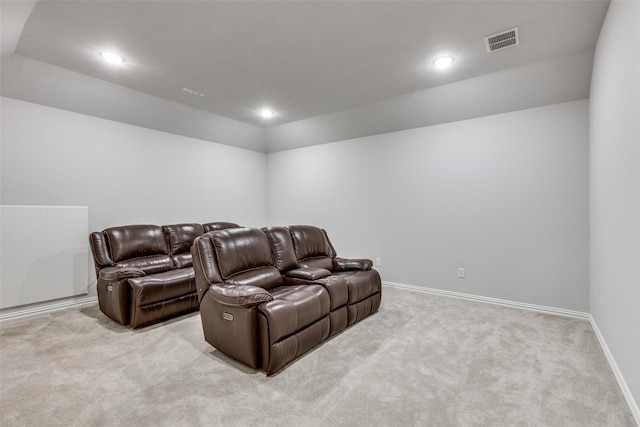 cinema room featuring light colored carpet