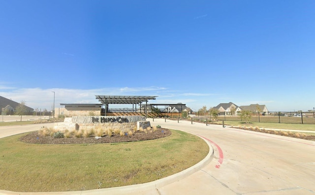 surrounding community with a yard and a pergola