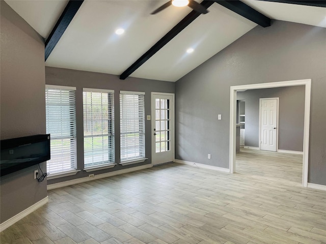 unfurnished living room featuring ceiling fan and lofted ceiling with beams