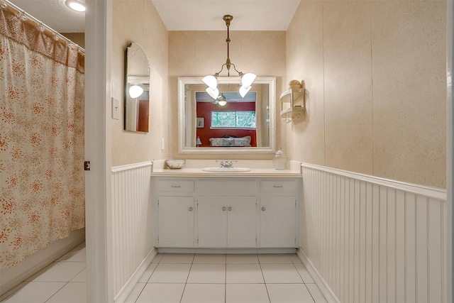 512 N Parkridge Dr, Mansfield, TX 76063 - bathroom with tile patterned flooring, vanity, ensuite bath, and a decorative wall