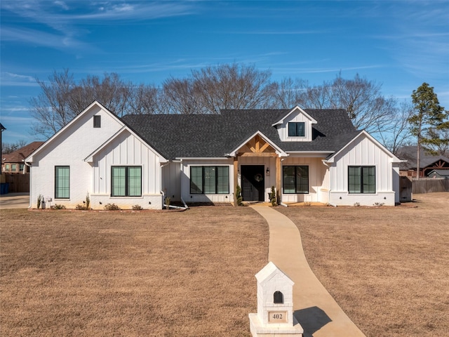 modern inspired farmhouse with a front yard