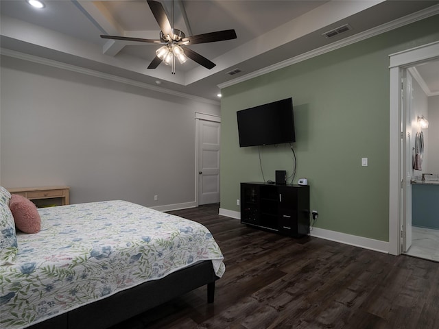 bedroom featuring ceiling fan, ensuite bathroom, dark wood-type flooring, and a tray ceiling