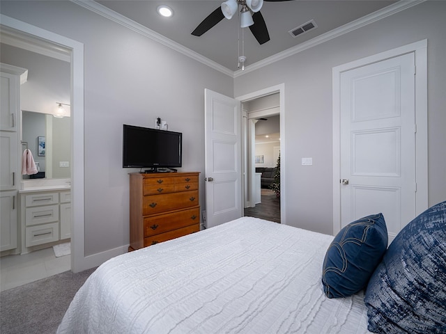 bedroom featuring ceiling fan, crown molding, connected bathroom, and light carpet