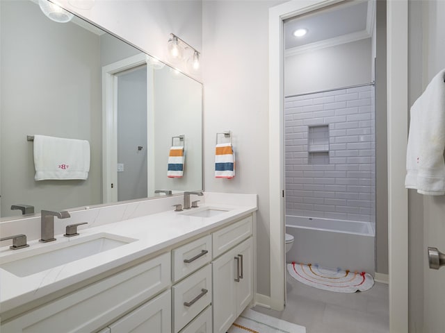 full bathroom featuring tile patterned floors, ornamental molding, vanity, toilet, and tiled shower / bath