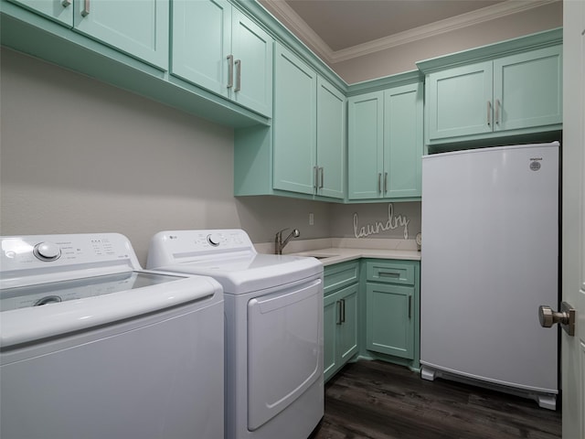 washroom featuring sink, cabinets, dark hardwood / wood-style flooring, washer and dryer, and ornamental molding