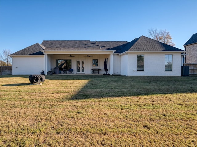 back of property with ceiling fan, a yard, and french doors